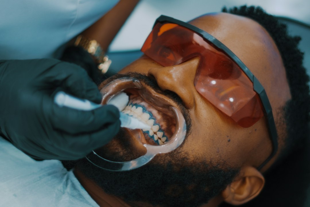 Patient wearing protective glasses and a lip retractor during an in-office dental procedure